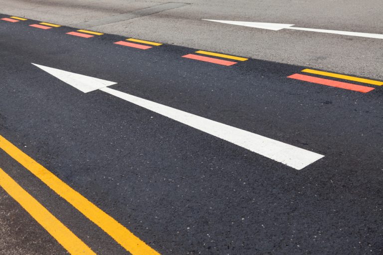 What impact does wet weather have on the road markings and how does it contribute to the overall safety during rainy conditions?  Is the surface resistance different for painted and non-painted surfaces?